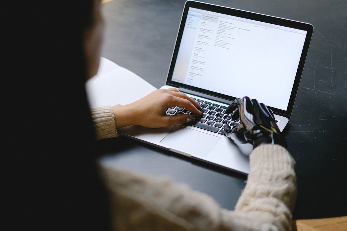 A woman using a laptop at a table.